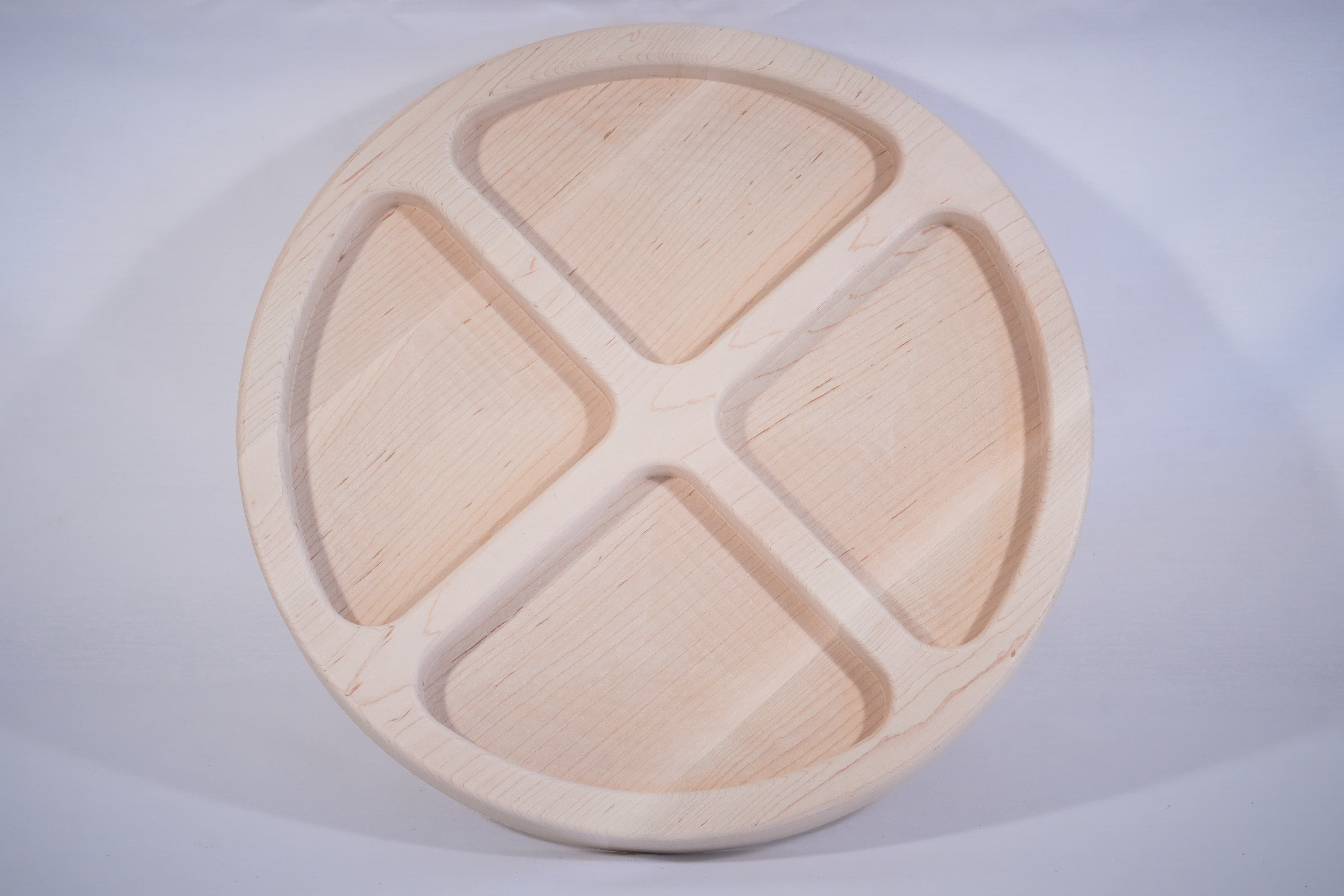 A piece of maple with pockets milled by a CNC machine