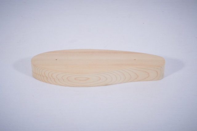 A wooden blank for a fishing lure cut by a CNC machine